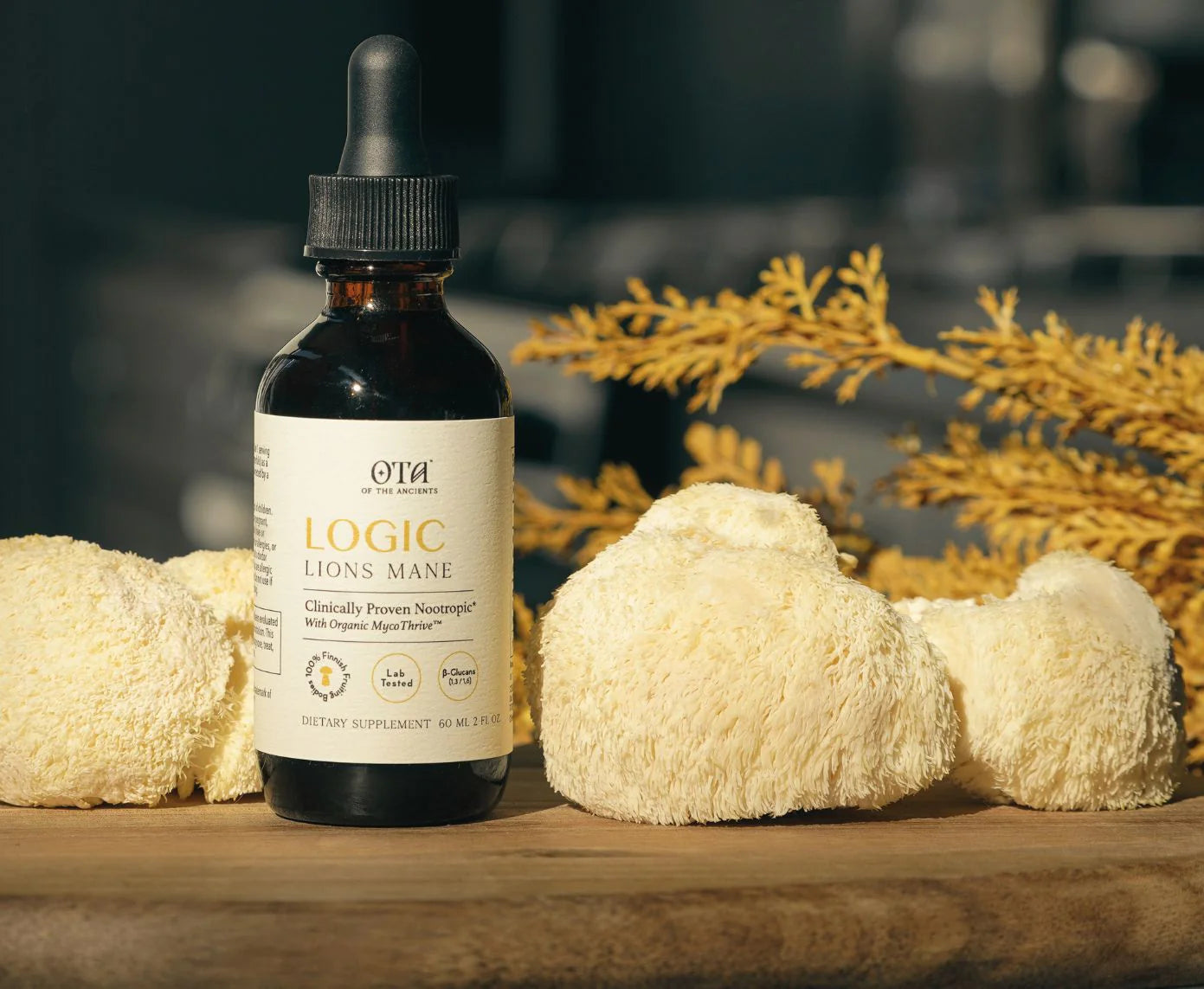Bottle of Logic Lions Mane supplement with lion's mane mushrooms on a wooden surface